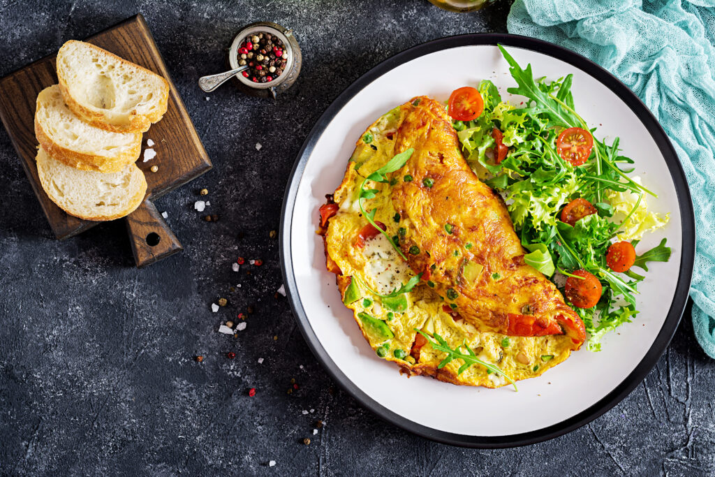 Breakfast.,Omelette,With,Tomatoes,,Avocado,,Blue,Cheese,And,Green,Peas
